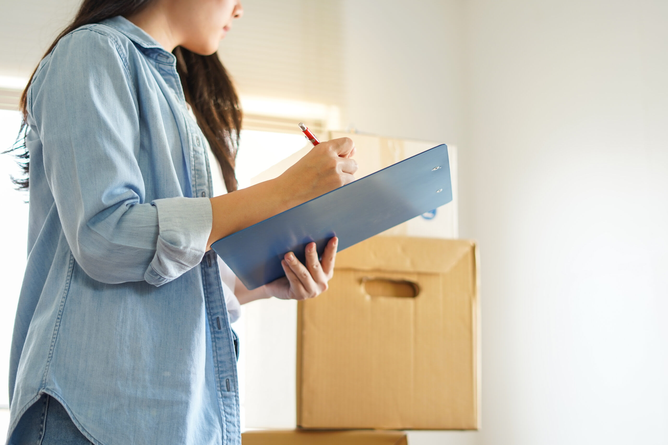 A caregiver helps a loved one pack for memory care.